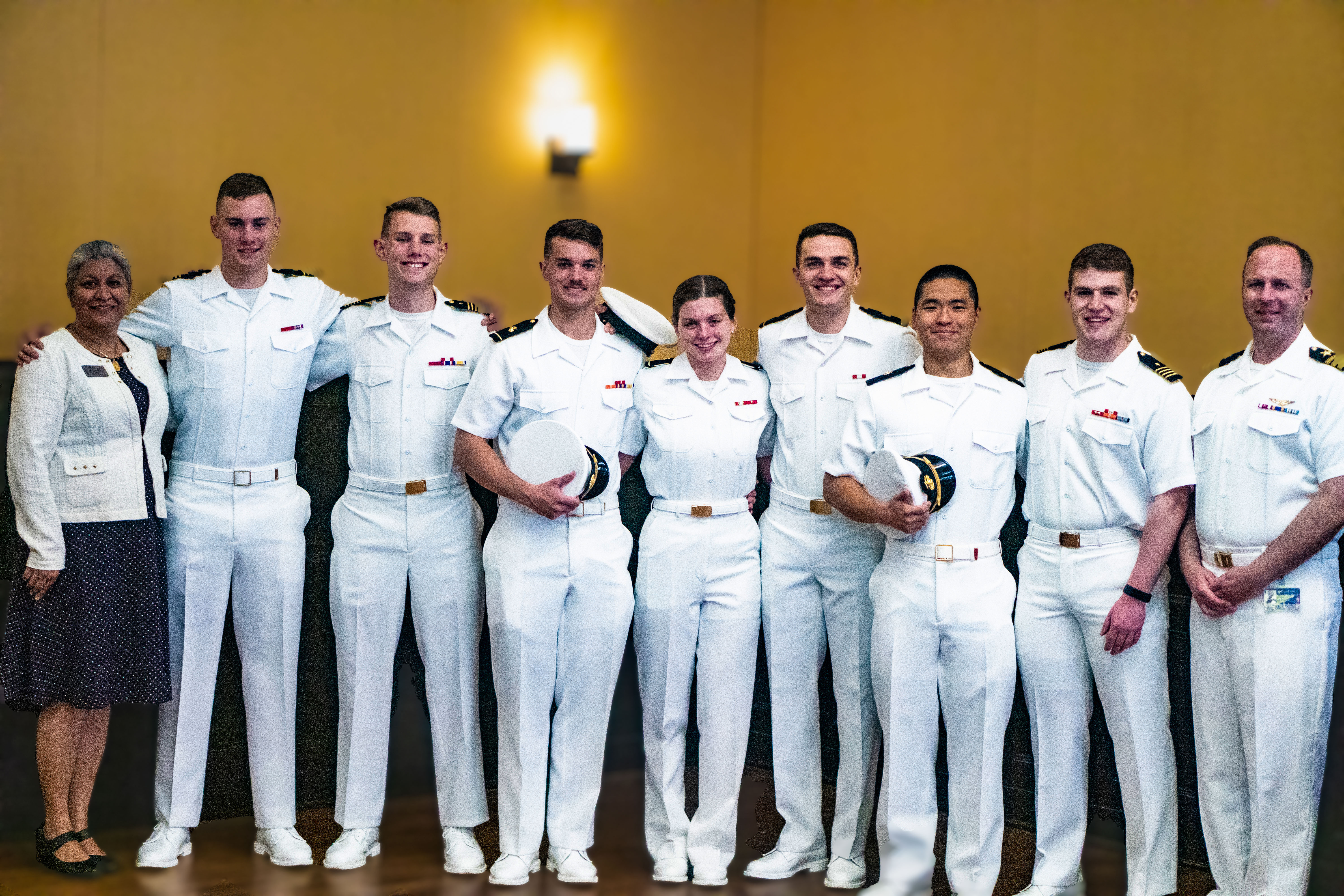 Students in naval uniforms stand together